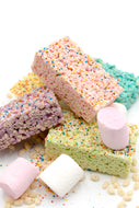 A colorful assortment of rice crispy treats in pink, purple, green, yellow, and blue layers, each topped with multicolored sprinkles. The treats are arranged in a playful stack with a few marshmallows and crisped rice pieces scattered around. This vibrant and fun presentation highlights the variety and festive appeal of the treats, making them perfect for celebrations or as a delightful snack.