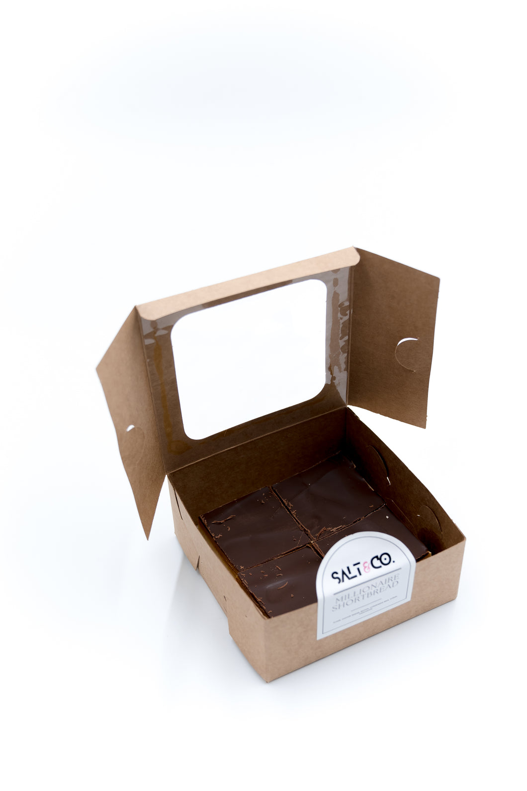 an open Salt & Co box of four millionaire shortbreads on a white background.