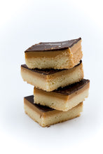 Load image into Gallery viewer, 4 Millionaire shortbreads stacked on a white background 
