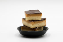 Load image into Gallery viewer, three millionaire shortbreads in a black bowl with a white background
