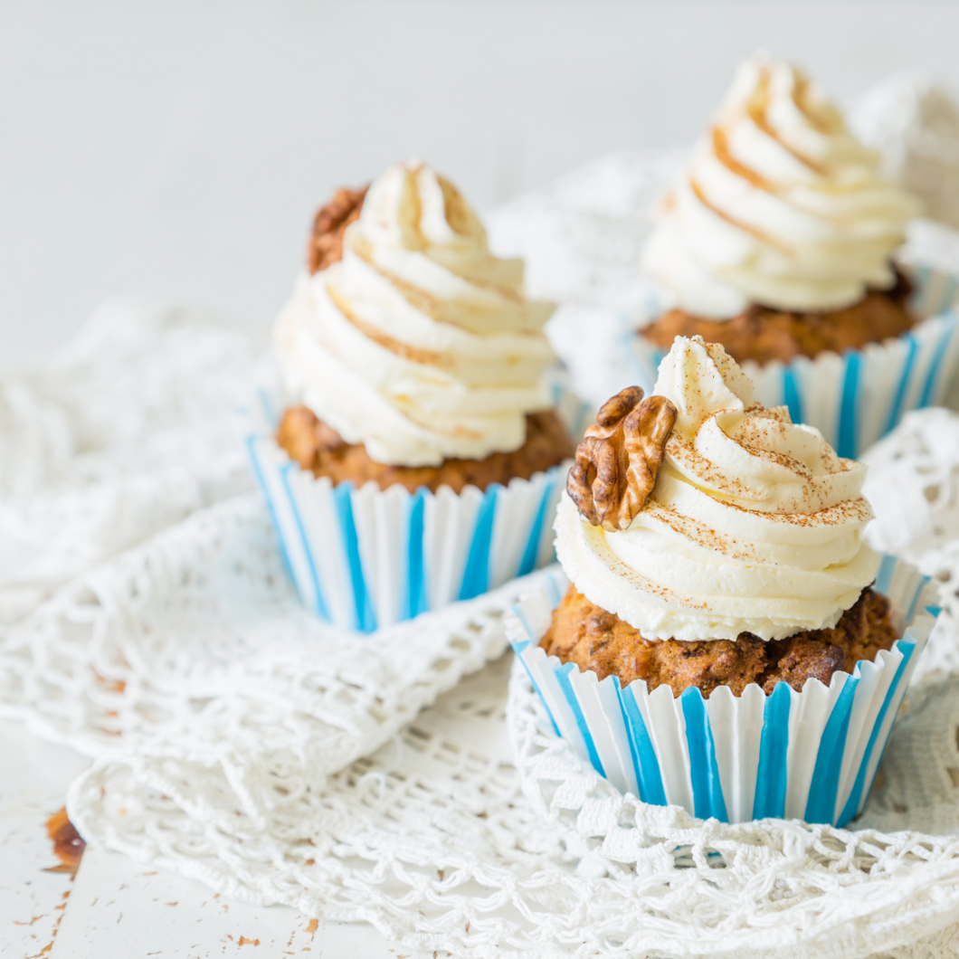 3 carrot cupcakes in blue and white wrappers