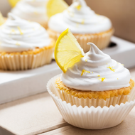 Lemon Meringue cupcakes on a box, with a slice of lemon for garnish